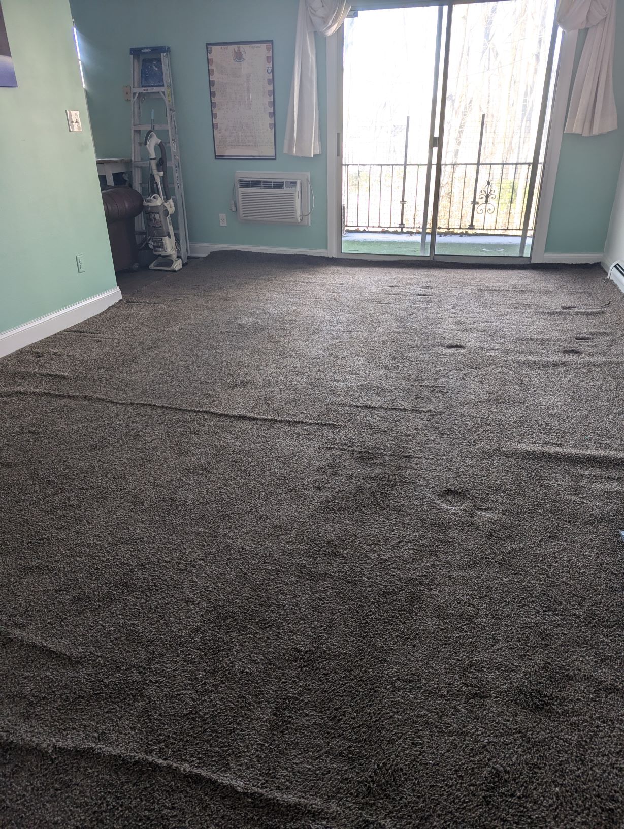 carpet stretching service provided by Five Star Carpet Service. Before picture